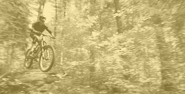 Biker jumping on a trail